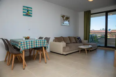 a living room with a couch and a table at Green Life One-Bedroom Apartment with Sea View by Flаt Manаger in Sozopol
