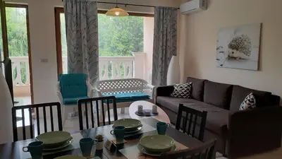 a living room with a couch and a table and chairs at RELAX Apartment in Varna South Bay Residence in Varna City