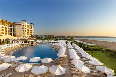 a group of umbrellas and a swimming pool at a resort at Alua Helios Bay - All Inclusive in Obzor