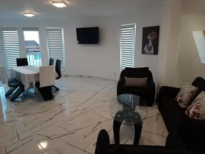a living room with a couch and chairs and a table at Incanto Apartments in Sveti Vlas