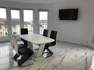 a conference room with a table and chairs and a flat screen tv at Incanto Apartments in Sveti Vlas