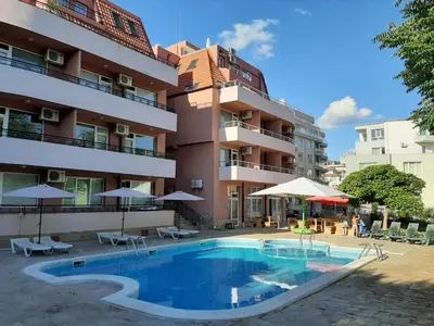 a swimming pool in front of a building at Incanto Apartments in Sveti Vlas