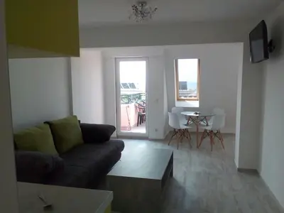 a living room with a couch and a table at Incanto Apartments in Sveti Vlas