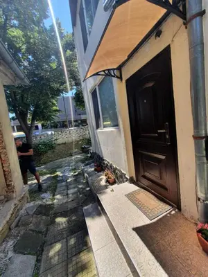 a door of a house with a sidewalk next to it at Top Center Apartment and Rooms Varna in Varna City