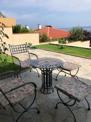 a patio with two chairs and a table and a bench at Solinaria Boutique Hotel in Sozopol