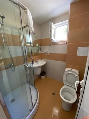 a bathroom with a shower and a toilet and a sink at Solinaria Boutique Hotel in Sozopol