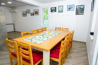 a dining room table with chairs and a tablecloth on it at Luxury House In Chervenka next to Gradina beach in Chernomorets