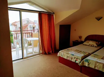 a bedroom with a bed and a view of a balcony at Solis in Primorsko
