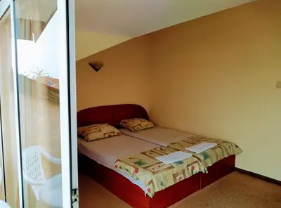 a small bedroom with a bed in a room at Solis in Primorsko
