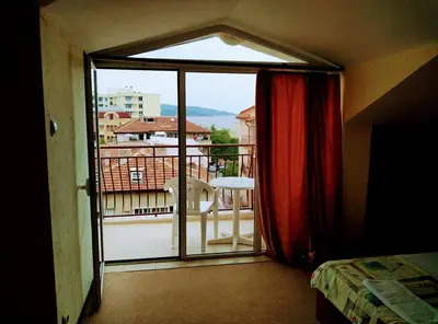 a room with a view of a balcony with a bed at Solis in Primorsko