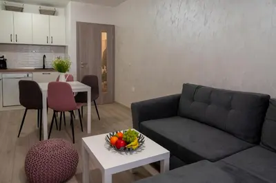 a living room with a couch and a table with a bowl of fruit at SOS CoMFORT in Burgas City