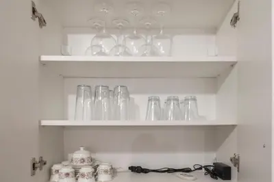 a shelf filled with glasses and other glass items at SOS CoMFORT in Burgas City