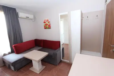 a living room with a couch and a table at Hotel PERLA BEACH in Sozopol