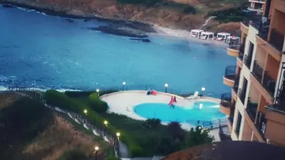 a view of a swimming pool next to a beach at VIP Sunrise Apartment in Lozenets