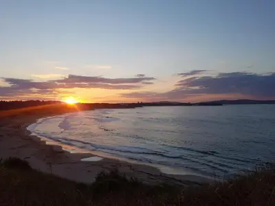 a sunset on a beach with the ocean at VIP Sunrise Apartment in Lozenets