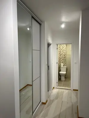 a bathroom with a toilet and a glass door at Kati apartments in Varna City