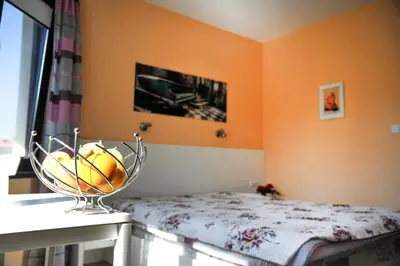 a bowl of fruit on a table in a bedroom at Къща за гости АКАЦИЯ in Ravna Gora
