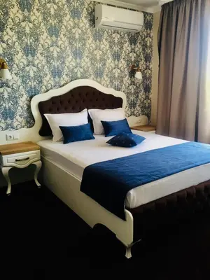 a bedroom with a large bed with blue pillows at Sunny Apartments Obzor in Obzor
