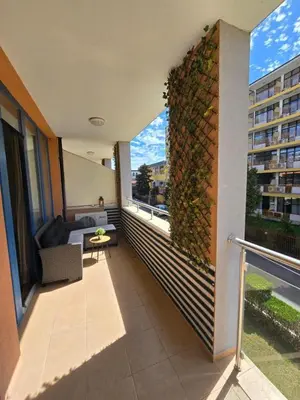 a balcony with a ivy wall on a building at Apartment in Trakia Plaza complex in Sunny Beach