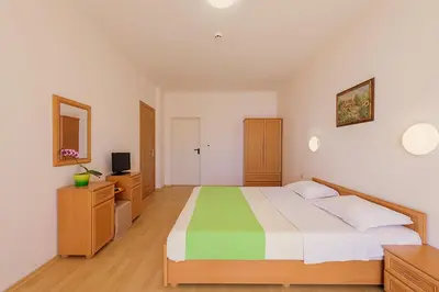 a bedroom with a large bed and a television at Apartment in Trakia Plaza complex in Sunny Beach