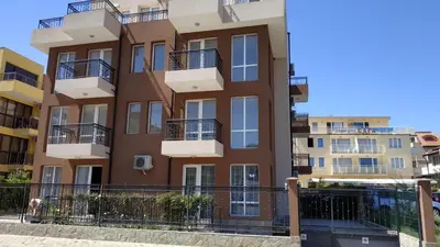 an apartment building with balconies on a city street at Complex Argo ap.2 in Ravda