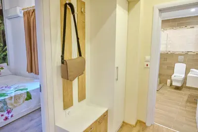 a small room with a bed and a bathroom at Luxury Nevena Apartment - Bogoridi super centre in Burgas City