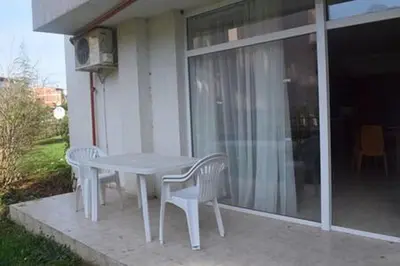 a white table and chairs on the porch of a house at Yves 2 Bed apart at Sun Village Sunny Beach not far away from the sea in Sunny Beach