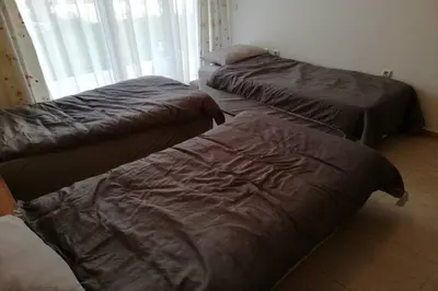 three beds sitting in a room with a window at Yves 2 Bed apart at Sun Village Sunny Beach not far away from the sea in Sunny Beach