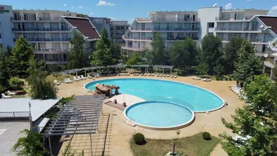 a large swimming pool in a city with buildings at Yves 2 Bed apart at Sun Village Sunny Beach not far away from the sea in Sunny Beach