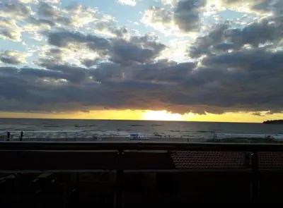 a sunset on the beach with a cloudy sky at Mare Nero in Sozopol