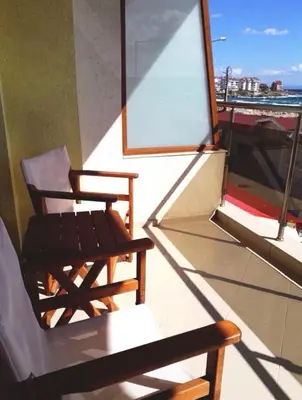 a chair on a balcony with a view of the ocean at Mare Nero in Sozopol
