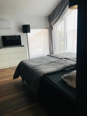 a bedroom with a bed and a large window at Вила ОмниЯ in Chernomorets