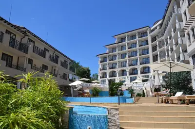 a hotel with a swimming pool in front of a building at Studio at 