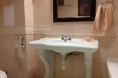 a bathroom with a white sink and a mirror at Studio at 