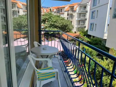 a balcony with a table and chairs on a balcony at Студио Одеса 22 in Sozopol