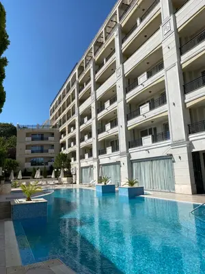 a swimming pool in front of a building at Private Apartments by the sea with a large terrace in Apart hotel! in Pomorie