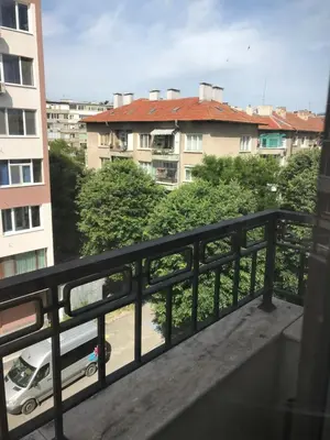a balcony with a view of a street and buildings at Sunny Shore Burgas Apartment in Burgas City