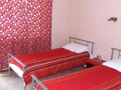two beds in a room with red curtains at Varnaflats Guest Rooms in Varna City