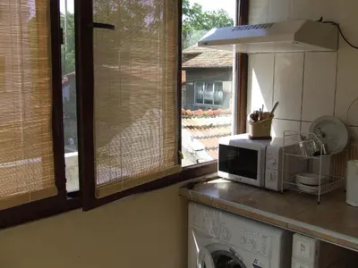 a kitchen with a microwave on top of a washing machine at Varnaflats Guest Rooms in Varna City