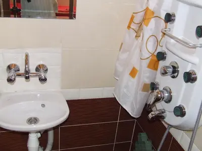 a bathroom with a sink and a shower at Varnaflats Guest Rooms in Varna City