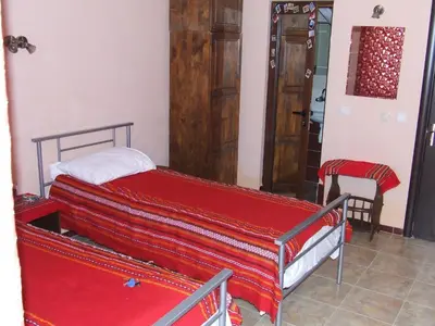 a bedroom with a bed with red sheets on it at Varnaflats Guest Rooms in Varna City
