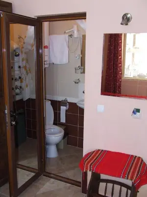 a bathroom with a toilet and a sink at Varnaflats Guest Rooms in Varna City