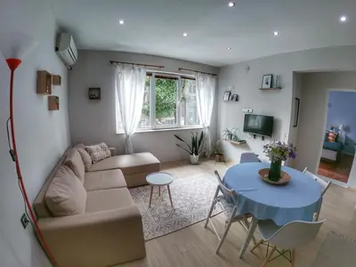 a living room with a couch and a table at Into The BLUE, 4 guests, 5 min away from the BEACH in Varna City