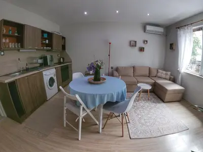 a kitchen and a living room with a table and chairs at Into The BLUE, 4 guests, 5 min away from the BEACH in Varna City
