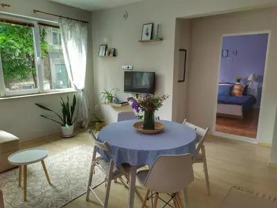 a living room with a blue table and chairs at Into The BLUE, 4 guests, 5 min away from the BEACH in Varna City