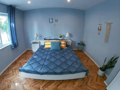 a bedroom with a bed with blue and orange pillows at Into The BLUE, 4 guests, 5 min away from the BEACH in Varna City