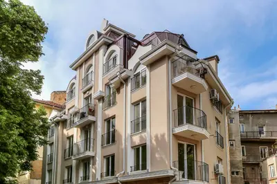 a building with balconies on the side of it at Deluxe studio Center city in Varna City