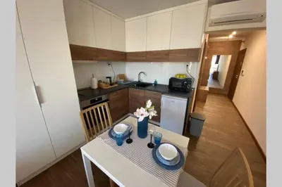 a small kitchen with a table with flowers on it at Studio 13 in Varna City