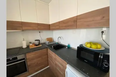 a kitchen with a microwave and a plate of fruit on the counter at Studio 13 in Varna City