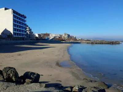 a view of the beach in front of a building at Айвазовский парк in Pomorie